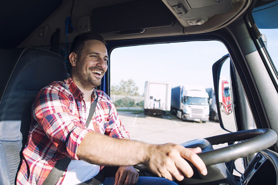 Specialized Business Insurance - Portrait Of Happy Truck Driver Driving His Truck