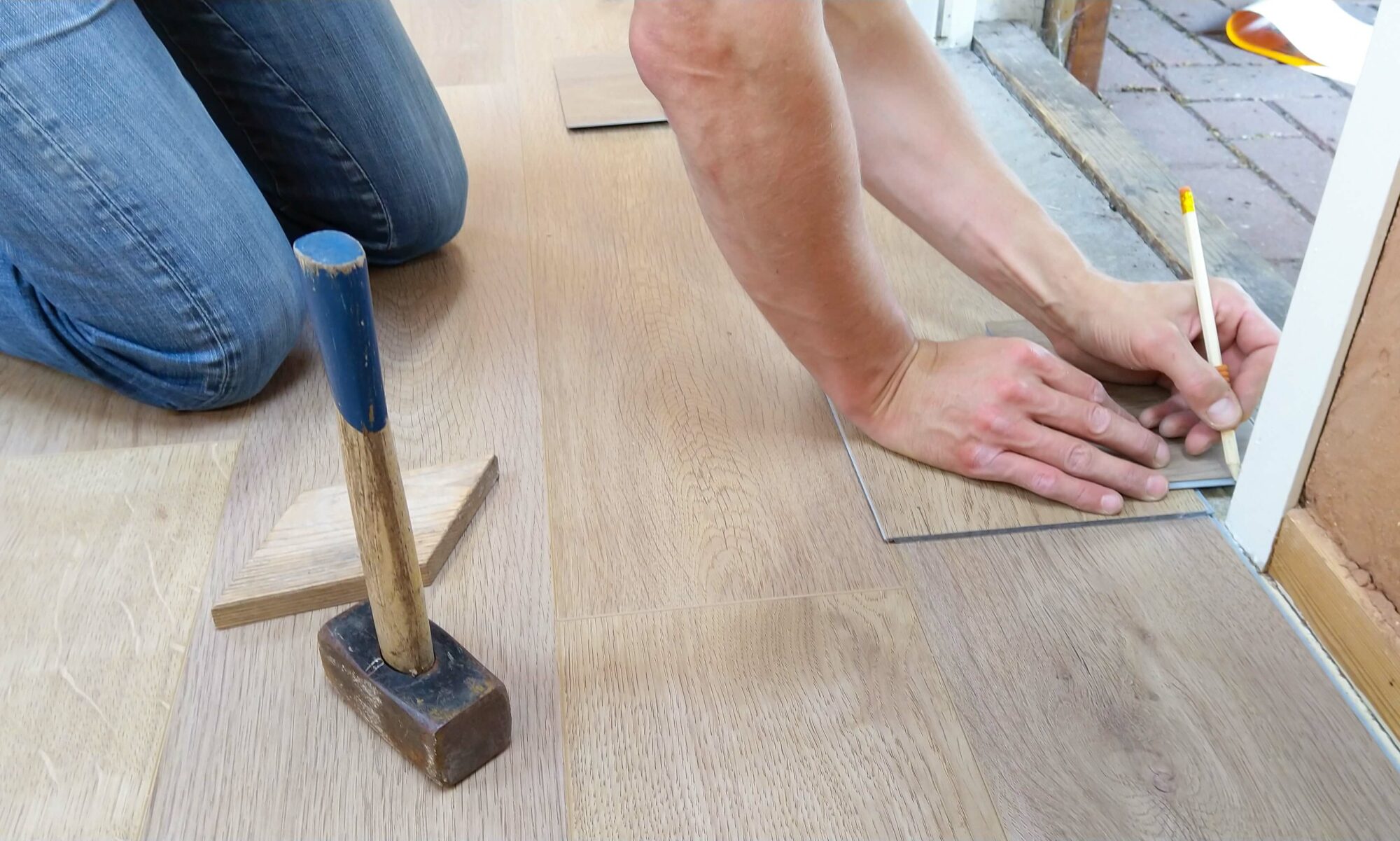 Stock image of man replacing flooring.